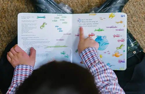 Preschool child/student reading at Woodlands Treehouse Preschool