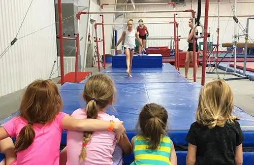 Westwood Gymnastics and Dance; young gymnastic students watching and learning in class